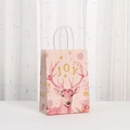 Detailed view of pink gift bag with reindeer illustration and white rope handle - Pink Reindeer