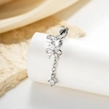 Silver bow and heart zircon stud earring with chain drop on a white display stand - White