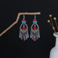 Artistic detail of Bohemian drop earrings with colorful beads hanging on a wooden branch - Colorful Red Blue Enamel Tassel Style (E6142-5)