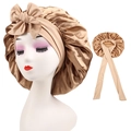 Macro detail of champagne gold satin sleep bonnet with adjustable ribbon and silk texture - Cross-Gold