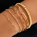 Close-up of five-piece gold layered bracelet set with heart charms and beaded chains - Gold Round Disc Paperclip Chain Five-piece Set Style (4716) / Gold