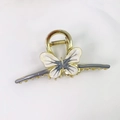 Elegant gold butterfly hair claw clip with cream and grey enamel finish for styling - Gray