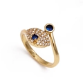 Golden evil eye ring with blue and white pavé cubic zirconia on a white background - Asymmetric Blue Diamond Style (CY-N0009)