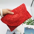 Detail of red handmade woven corn husk clutch bag with intricate fan-shaped straw patterns - Red