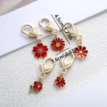 Cierres de corazón dorados con dijes de flores de cerezo y rosas en esmalte rojo - Serie Roja (ER721)