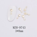 Detailed view of 3x8mm golden alloy key nail art charms on a white textured fabric - Gold Key Style (MZH-9743) / 3*8mm