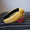 Close-up of yellow and beige woven raffia headband with a stylish knotted design detail - Yellow Series Knotted