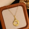 Detail view of a gold triple-layer concentric circle pendant on a fine metal chain - Gold Triple Layer Concentric Circle Necklace