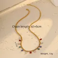 Macro shot of gold stainless steel necklace featuring colorful teardrop crystal pendants - Water Drop / Colorful