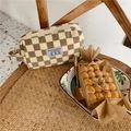 Detail of checkered corduroy cosmetic bag with side handle and Wild Flower label - Light Brown Checkerboard