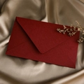 Detail of dark red textured paper envelope on champagne silk background with dried flower - 1pc Linen Deep Red Envelope / Dark Red