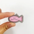 Detailed view of a small fish-shaped rhinestone pet photo frame pendant held by hand - Fish Shape Style