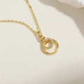 Golden double geometric circle necklace with sparkling zircon pavé on inner ring - Double Ring Zirconia (14K Gold Plated) / Gold