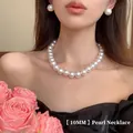 Close-up of 10mm white pearl necklace and stud earrings set on a model with roses - Gold 10mm Pearl