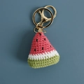 Handmade crochet watermelon keychain with red and green yarn and golden clasp - Pink