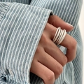 Silver multi-layered ring with a twisted texture design on a model's hand - JZ1235 (Twisted Texture)