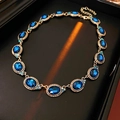 Vintage gold necklace with a blue oval gemstone and sparkling rhinestones on a display box - 4# Necklace Rhinestone Oval Pendant