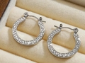 Close-up of silver hoop earrings with Greek key pattern in a velvet jewelry box - Silver Style K7-102