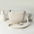 Minimalist cream white half-moon crossbody bag in premium lychee grain leather texture - Off White
