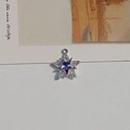 Detailed view of a silver star pendant with purple gradient crystal and pave crystals - Purple Star