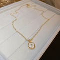 Gold stainless steel necklace featuring a round mother of pearl rose pendant charm - Gold Flower Style
