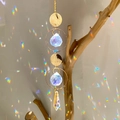 Golden suncatcher with crystal ball creating rainbow light reflections on the wall - B21 Style