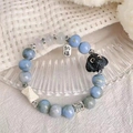 Handmade beaded bracelet with blue stone, dog charm and silver blessing tag - Blue-Black-Dog Fortune