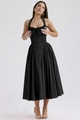 Detailed view of black halter neck dress featuring slim waist and pleated long hemline - Black