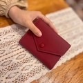 Slim burgundy leather wallet for women with pebble texture and envelope flap closure - Bordeaux