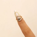Detail view of gold Evil Eye nail ring with white zircons and a black pupil stone - Arch Nail Ring Style (4929) / KC Gold