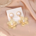 Elegant gold hollow flower earrings featuring white pearls and a vintage aesthetic design - Style 25092909-4