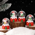Set of four Christmas snow globes with Santa Claus and snowman on red starry bases - 205# (lights + Snowflakes) / 45# (cardboard Box Packaging)