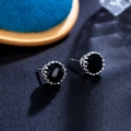 Macro shot of 8mm black zircon crown stud earrings featuring silver prong settings - Black 8mm