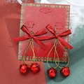 Christmas themed bell earrings with red bows and golden accents on festive background - 12 Red Bow Double Bell