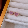 Macro shot of rose gold heart earrings with purple mother-of-pearl and beaded edges - Purple Heart Style