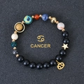Detail of beaded solar system bracelet with Cancer zodiac sign and golden star charm - Cancer