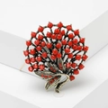 Vintage bronze flower brooch with vibrant red beads and rhinestones on a white background - Red