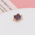 Macro shot of purple square zircon charm with gold double loops for DIY jewelry - Purple