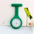 Detail of green silicone nurse watch with white quartz dial against artistic background - Dark Green