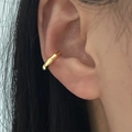 Single gold geometric ear cuff with micro-pave cubic zirconia on a female model - U-Shape Metal Earrings - Gold (EP5620)