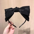 Elegant black oversized satin bow headband with a glossy finish for women's hair styling - Black
