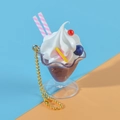 Chocolate ice cream sundae keychain with white cream and pink straw in a mini cup - Brown
