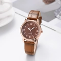 Detailed macro view of a stylish quartz watch with brown leather strap and rose gold case - Coffee