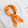 Minimalist square scarf in solid orange silk finish tied on a white t-shirt - Orange