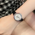 Elegant women's watch featuring black leather strap and textured silver dial on wrist - Silver Case Black Leather