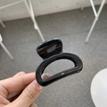Detail shot of a glossy black hollow square hair claw clip for high ponytail styling - Glossy Black