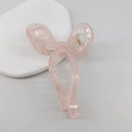 Translucent pastel pink bow-shaped hair claw clip with a glossy resin finish - Transparent Light Pink