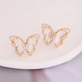 Macro view of gradient butterfly earrings with gold plating and cubic zirconia inlay - AB White