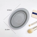 Grey silicone makeup brush cleaning mat in oval shape with multiple textures and 14.5cm length - Ellipse / Gray