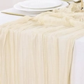 Elegant cream crinkle gauze table runner draped over a minimalist wedding reception setting - Off White